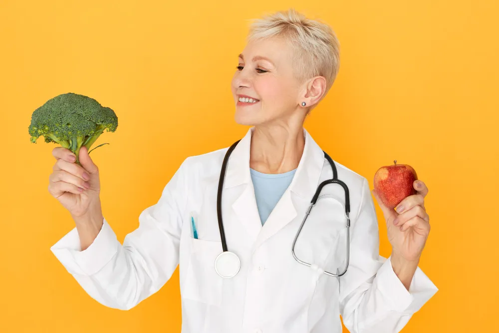 doctor holding fruit on an orange background